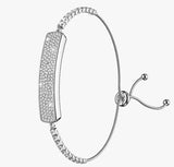 A silver-toned adjustable wire bracelet featuring a curved rectangular plate paved with small clear stones, shown on a plain light gray background.